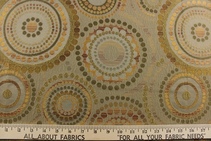 This contemporary geometric design features overlapping circles and dots in beige, brown, gold, green and copper colors.