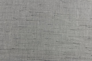  Voltaire is a woven, textured fabric in silver grey.  It has a slub yarn running across the the fabric which creates the look of silk with a soft, drapable hand.  The weight is suited for draperies, light upholstery, headboards, decorative pillows, coverlets and cornice boards.  We offer Voltaire in several different colors.