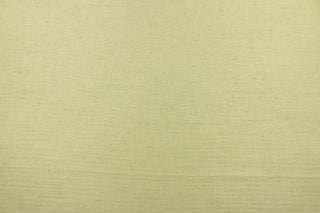  Voltaire is a woven, textured fabric in light green.  It has a slub yarn running across the the fabric which creates the look of silk with a soft, drapable hand.  The weight is suited for draperies, light upholstery, headboards, decorative pillows, coverlets and cornice boards.  We offer Voltaire in several different colors.