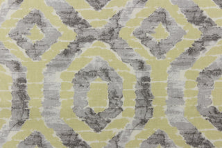 This beautiful fabric features a geometric design in gray and a pale yellowish green color with hints of white.