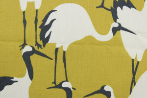 The Robert Allen© Winter Crane in Goldenrod features a combination of ivory and black, set against a golden background. This versatile piece, with its multi-purpose usage, is perfect for bringing a cozy and inviting atmosphere into your home. It can be used for several different statement projects including window accents (drapery, curtains and swags), toss pillows, headboards, bed skirts, duvet covers, light duty upholstery, and more.