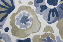Load image into Gallery viewer, This fabric features large watercolor flowers with shades of blue, beige, and tan accompanied by a white background. Its strength is unrivaled, offering 100,000 double rubs. In addition, the fabric is soil and stain resistant, giving you lasting protection from common messes  It can be used for several different statement projects including window accents (drapery, curtains and swags), toss pillows, headboards, bed skirts, duvet covers, upholstery, and more.
