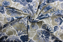 Load image into Gallery viewer, This fabric features large watercolor flowers with shades of blue, beige, and tan accompanied by a white background. Its strength is unrivaled, offering 100,000 double rubs. In addition, the fabric is soil and stain resistant, giving you lasting protection from common messes  It can be used for several different statement projects including window accents (drapery, curtains and swags), toss pillows, headboards, bed skirts, duvet covers, upholstery, and more.
