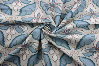  a large floral print with soft colors of plum, blue, white and yellow, this multipurpose fabric features a light taupe background for lasting appeal. Certified with 30,000 double rubs and treated with a soil and stain repellant finish, this fabric is perfect for bringing your interior design ideas to life.  It can be used for several different statement projects including window accents (drapery, curtains and swags), toss pillows, headboards, bed skirts, duvet covers, upholstery, and more.