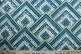 Bring a touch of elegance to any room with the Robert Allen© Mirrored in Tourmaline fabric.  Featuring a multiuse geometric print in shades of blue and green with white accents, this fabric is built to last with 30,000 double rubs and soil and stain resistant performance for easy maintenance.  It can be used for several different statement projects including window accents (drapery, curtains and swags), toss pillows, headboards, bed skirts, duvet covers, upholstery, and more.