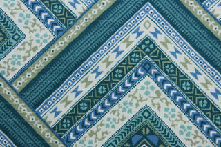 Bring a touch of elegance to any room with the Robert Allen© Mirrored in Tourmaline fabric.  Featuring a multiuse geometric print in shades of blue and green with white accents, this fabric is built to last with 30,000 double rubs and soil and stain resistant performance for easy maintenance.  It can be used for several different statement projects including window accents (drapery, curtains and swags), toss pillows, headboards, bed skirts, duvet covers, upholstery, and more.