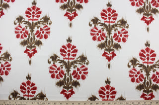 Robert Allen© Manon in Red is a multipurpose fabric featuring an Ikat pattern with brown and dark red against a white background.  Spills and stains won't adhere as the fabric is soil and stain repellant.  It can be used for several different statement projects including window accents (drapery, curtains and swags), toss pillows, headboards, bed skirts, duvet covers and upholstery. 