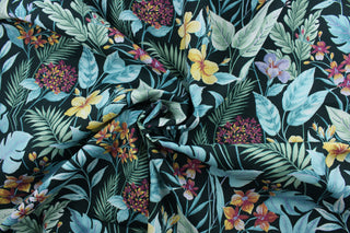 The Richloom Solarium© Cavena in Teal fabric combines a tropical floral print in green, teal, yellow, light purple, and dark magenta on a black background, resulting in a versatile fabric that's perfect for any project.  Its vibrant colors will bring a bold aesthetic to any space.  This fabric is U/V fade and water/stain resistant.  Perfect for porches, patios and pool side.  Uses include toss pillows, cushions, upholstery, tote bags and more. 