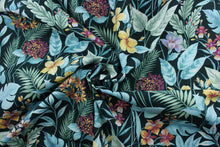 Load image into Gallery viewer, The Richloom Solarium© Cavena in Teal fabric combines a tropical floral print in green, teal, yellow, light purple, and dark magenta on a black background, resulting in a versatile fabric that&#39;s perfect for any project.  Its vibrant colors will bring a bold aesthetic to any space.  This fabric is U/V fade and water/stain resistant.  Perfect for porches, patios and pool side.  Uses include toss pillows, cushions, upholstery, tote bags and more. 
