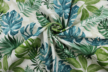Load image into Gallery viewer,  The Richloom Solarium© Piermont in Palm print contains bold, tropical palm leaves in shades of blue, green, and beige, making it ideal for outdoor multipurpose use.  It has been tested to resist 500 hours of exposure to sunlight.  The fabric is also water and stain resistant.  Perfect for porches, patios and pool side.  Uses include toss pillows, cushions, upholstery, tote bags and more. 
