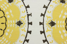 Load image into Gallery viewer, The Robert Allen© Medallion Band is the perfect combination of style and performance. Its multi purpose medallion print provides a captivating look, and its citrine, brown, and white colors bring a subtle, natural feel.  With 30,000 double rubs, this fabric is highly durable.  It can be used for several different statement projects including window accents (drapery, curtains and swags), toss pillows, headboards, bed skirts, duvet covers, upholstery, and more.
