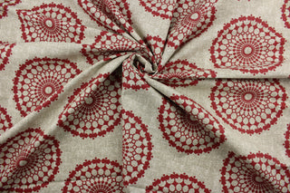 Featuring a contemporary print with spirograph medallions in a vibrant pomegranate hue on a mottled faded tan and ivory background, this fabric is built to last with 50,000 double rubs. It can be used for several different statement projects including window accents (drapery, curtains and swags), toss pillows, headboards, bed skirts, duvet covers, upholstery, and more.