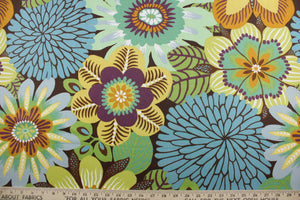 This multipurpose fabric features a large floral print and an array of bright and subtle colors including green, yellow, orange, blue, purple, and white, all set against a warm brown background.  Crafted with soil and stain repellant, this luxe fabric is sure to enliven any room.  It can be used for several different statement projects including window accents (drapery, curtains and swags), toss pillows, headboards, bed skirts, duvet covers and upholstery. 
