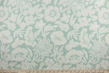 Load image into Gallery viewer, The Robert Allen© Thea Damask in Indigo, a multipurpose fabric, features a large floral print in aloe, beige, and white. Constructed for durability, it is rated for 100,000 double rubs and is soil and stain resistant.  It can be used for several different statement projects including window accents (drapery, curtains and swags), toss pillows, headboards, bed skirts, duvet covers, upholstery, and more.
