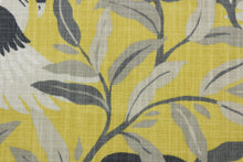 Load image into Gallery viewer, The Robert Allen© Swanwood in Saffron is the perfect choice for a playful and durable look in any room.  It features a unique and cheerful design of gray and beige swans dancing on citrine and gray vines.  With 65,000 double rubs, this multipurpose fabric is sure to look great for years to come.  Perfect for window treatments (draperies, valances, curtains, and swags), upholstery, bed skirts, duvet covers, pillow shams and accent pillows.
