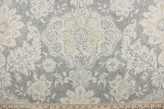 features an intricate damask floral design printed on a cotton duck base for a multipurpose use.  The unique design has an aged and distressed look, with golden tan and natural tones on a gray background.  The versatile fabric is perfect for window accents (draperies, valances, curtains and swags) cornice boards, accent pillows, bedding, headboards, cushions, ottomans, slipcovers and upholstery. 