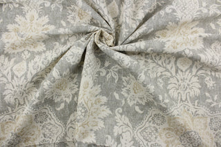 features an intricate damask floral design printed on a cotton duck base for a multipurpose use.  The unique design has an aged and distressed look, with golden tan and natural tones on a gray background.  The versatile fabric is perfect for window accents (draperies, valances, curtains and swags) cornice boards, accent pillows, bedding, headboards, cushions, ottomans, slipcovers and upholstery. 