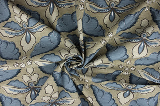 Showcasing a large floral print in the colors of indigo, white, brown, and tan this multipurpose fabric features a camel brown background for lasting appeal. Certified with 30,000 double rubs and treated with a soil and stain repellant finish, this fabric is perfect for bringing your interior design ideas to life.  It can be used for several different statement projects including window accents (drapery, curtains and swags), toss pillows, headboards, bed skirts, duvet covers, upholstery, and more.