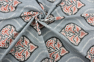 Robert Allen© Kavali in Persimmon fabric is a multi-purpose fabric with a geometric print in persimmon, charcoal, and white against a light slate blue background.  It features excellent durability with a 65,000 double rub rating.  It can be used for several different statement projects including window accents (drapery, curtains and swags), toss pillows, headboards, bed skirts, duvet covers and upholstery. 