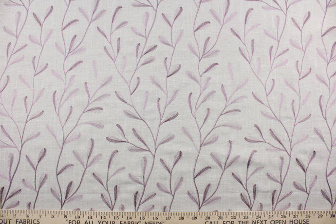 The Embroidered Tangle in Beige Crocus features a stunning vine leaf design in lavender set against a beige background.  The elegant design adds an elegant touch to any space. Its multi-purpose use makes it a versatile choice for drapery, pillows, light upholstery, table runners, bedding, headboards, home décor, and even apparel. 