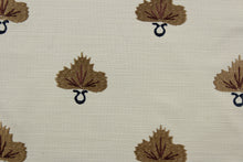 Load image into Gallery viewer, Effortlessly elevate any space with the versatile and elegant Embroidered August in Putty Cognac.  The finely embroidered golden brown medallion with dark navy blue and cognac accents, set against a putty background adds a touch of sophistication to drapery, pillows, light upholstery, table runners, bedding, headboards, home décor, and even apparel. Perfect for any style or purpose.
