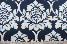 Load image into Gallery viewer, The Robert Allen© Palm Gardens in Indigo fabric is a multipurpose fabric with a tropical palm leaf design in white and light blue set against an indigo blue background. Durable and easy to clean, this fabric is designed to withstand up to 10,000 double rubs. It can be used for several different statement projects including window accents (drapery, curtains and swags), toss pillows, headboards, bedding, upholstery, and more.
