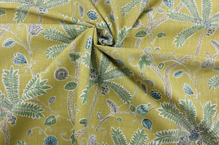 Robert Allen© Indienne Ink in Amber is a multi-purpose fabric featuring palm trees and plants. With a citrine background and green, turquoise amber, gray and white accents, it's sure to draw the eye.  It's also incredibly durable, boasting 65,000 double rubs and a soil and stain repellant finish.  It can be used for several different statement projects including window accents (drapery, curtains and swags), toss pillows, headboards, bed skirts, duvet covers, upholstery, and more.