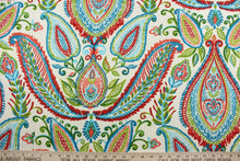 Load image into Gallery viewer, Robert Allen© Ombre Paisley in Poppy is a versatile multipurpose fabric made from a cotton basket weave.  The bright and colorful paisley design features an ombre effect in shades of red, coral, green, turquoise and blue against a light cream background.  It can be used for several different statement projects including window accents (drapery, curtains and swags), toss pillows, headboards, bed skirts, duvet covers, upholstery, and more.
