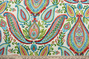 Robert Allen© Ombre Paisley in Poppy is a versatile multipurpose fabric made from a cotton basket weave.  The bright and colorful paisley design features an ombre effect in shades of red, coral, green, turquoise and blue against a light cream background.  It can be used for several different statement projects including window accents (drapery, curtains and swags), toss pillows, headboards, bed skirts, duvet covers, upholstery, and more.