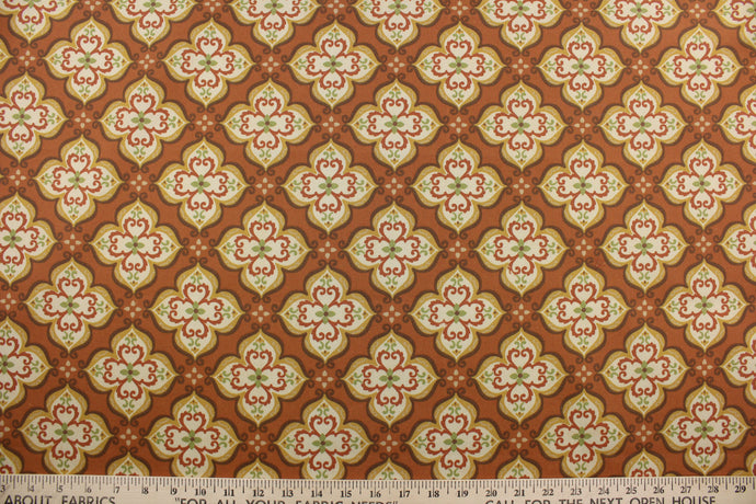 Robert Allen© Suri in India is a multipurpose indoor/outdoor fabric featuring an intricate medallion print in shades of brown, green, dark yellow, cream, and set on a teracotta background.  This fabric is U/V fade and water/stain repellant.  Perfect for porches, patios and pool side.  Uses include toss pillows, cushions, upholstery, tote bags and more. 