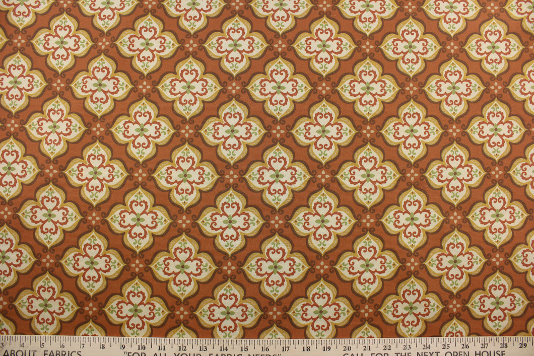 Robert Allen© Suri in India is a multipurpose indoor/outdoor fabric featuring an intricate medallion print in shades of brown, green, dark yellow, cream, and set on a teracotta background.  This fabric is U/V fade and water/stain repellant.  Perfect for porches, patios and pool side.  Uses include toss pillows, cushions, upholstery, tote bags and more. 