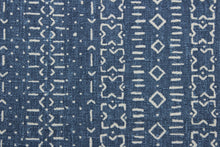 Load image into Gallery viewer,  Robert Allen© Bakosi in Twilight is a multipurpose fabric with a striking ethnic geometric print in a beautiful combination of blue and light cream.  This fabric is built to last with a 100,000 double rub rating.  It can be used for several different statement projects including window accents (drapery, curtains and swags), toss pillows, headboards, bed skirts, duvet covers, upholstery, and more.
