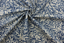 Load image into Gallery viewer, The Robert Allen© Indiki Blooms in Indigo fabric is perfect for multipurpose use, featuring a unique floral print that blends the indigo and natural colorways.  Made from highly durable cotton, this fabric offers up to 100,000 double rubs.  It can be used for several different statement projects including window accents (drapery, curtains and swags), toss pillows, headboards, bed skirts, duvet covers, upholstery, and more.
