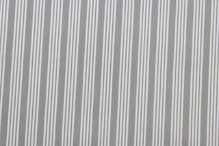 Robert Allen© Dateline is a versatile fabric with a horizontally vertically striped pattern.  Combining sterling gray with a crisp white hue, this luxurious fabric is perfect for modern décor.  It can be used for several different statement projects including window accents (drapery, curtains and swags), toss pillows, headboards, bed skirts, duvet covers, upholstery, and more.