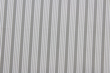 Load image into Gallery viewer, Robert Allen© Dateline is a versatile fabric with a horizontally vertically striped pattern.  Combining sterling gray with a crisp white hue, this luxurious fabric is perfect for modern décor.  It can be used for several different statement projects including window accents (drapery, curtains and swags), toss pillows, headboards, bed skirts, duvet covers, upholstery, and more.

