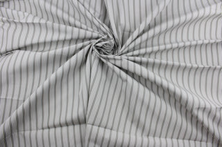 Robert Allen© Dateline is a versatile fabric with a horizontally vertically striped pattern.  Combining sterling gray with a crisp white hue, this luxurious fabric is perfect for modern décor.  It can be used for several different statement projects including window accents (drapery, curtains and swags), toss pillows, headboards, bed skirts, duvet covers, upholstery, and more.