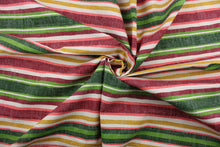 Load image into Gallery viewer, This heavy striped fabric in shades of green, red, dark yellow, and white would be a great accent to your home décor projects.  It it is perfect for window treatments, decorative pillows, handbags, light duty upholstery applications.  This fabric has a soft workable feel yet is stable and durable with 50,000 double rubs.  
