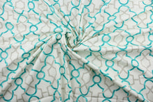 Load image into Gallery viewer, This printed cotton twill fabric features a geometric design in turquoise and grey on an off white background.  It is perfect for window treatments, decorative pillows, handbags, light duty upholstery applications.  This fabric has a soft workable feel yet is stable and durable with 50,000 double rubs.  
