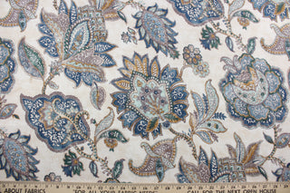  Covington© Foligno in Laguna is a versatile, beautiful fabric with a non-woven backing.  Its Jacobean floral print in shades of blue, aqua, deep gold/bronze, neutrals, and cream adds a touch of elegance to any project.  It can be used for several different statement projects including window accents (drapery, curtains and swags), toss pillows, bed skirts, and duvet covers.  It has a soft workable feel yet is stable and durable with 12,000 double rubs.