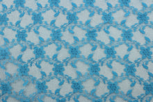 Load image into Gallery viewer, Our Woven Lace in Sapphire Blue is expertly crafted with a dainty floral design.  Add an elegant touch to any project with this high-quality lace.  Made with precision and attention to detail, our lace adds a sophisticated touch to your creations.  Uses include apparel, costumes, and home décor.
