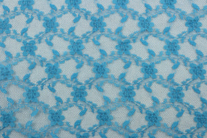 Our Woven Lace in Sapphire Blue is expertly crafted with a dainty floral design.  Add an elegant touch to any project with this high-quality lace.  Made with precision and attention to detail, our lace adds a sophisticated touch to your creations.  Uses include apparel, costumes, and home décor.