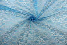 Load image into Gallery viewer,  Our Woven Lace in Royal Blue is expertly crafted with a delicate floral design.  Add an elegant touch to any project with this high-quality lace.  Made with precision and attention to detail, our lace adds a sophisticated touch to your creations.  Uses include apparel, costumes, and home décor.
