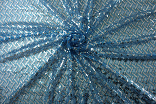  Enhance your style with Sequined Sparkle in Blue.  Silver sequins add a touch of glamour, while the blue tulle base brings a pop of color.  Perfect for adding sparkle to special occasion apparel, dancewear, costumes, overlays, table tops, and decorations. 
