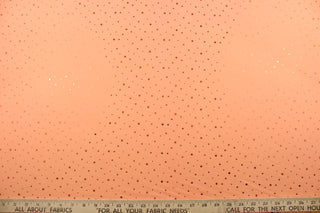 This product features a polyester base accented with shiny, sequined dots in peach.  The polyester material provides durability and the peach color adds a touch of elegance.  Enjoy ultimate comfort and flexibility with its 8 way stretch.  Perfect for adding sparkle to special occasion apparel, dancewear, costumes, overlays, table tops, and decorations. 