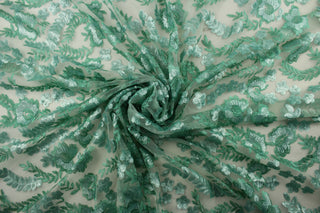 This green sequined net features an embroidered and sequined floral vine and delicate butterflies, adding a touch of elegance to any project.  The varying shades of green bring a natural and refreshing aesthetic.  Made with a tulle base, it is lightweight and easy to work with.   Perfect for adding sparkle to special occasion apparel, dancewear, costumes, overlays, table tops, and decorations. 