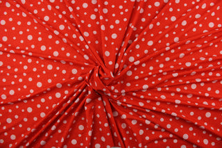 This Blood Orange Glitter Dots fabric features a vibrant polka dot pattern in white set against a blood orange background, with a hint of red glitter for added sparkle.  Enjoy 8 way stretch and comfortable wear while adding a pop of color to your creations.  Perfect for adding sparkle to special occasion apparel, dancewear, costumes, overlays, table tops, and decorations. 