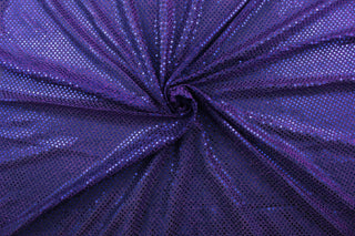 This semi-transparent tulle fabric is adorned with shimmering sequins, creating a beautiful and eye-catching effect in a vibrant purple color.&nbsp; Perfect for special occasion apparel, dancewear, costumes, overlays, table tops, and decorations.&nbsp;