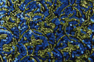 This Sequined Swirls design features a unique blend of blue and green sequins on a black base cloth.  The intricate swirl pattern adds a touch of elegance to any design.  Made from a high-quality 4 way stretch polyester and lycra© base, this fabric provides flexibility and durability.  Perfect for adding sparkle to special occasion apparel, dancewear, costumes, overlays, table tops, and decorations. 