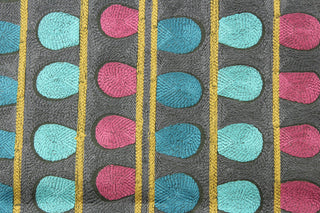 Expertly designed and versatile, the P/Kaufmann© Enigma in Mars fabric boasts a contemporary embroidered pattern of vertical stripes and oval shapes in dark fuchsia, teal, turquoise, gold, and dark gray. With 51,000 double rubs, it is perfect for any upholstery or drapery project, adding a touch of style and durability to your home décor.