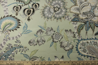  printed floral Jacobean motifs in various shades of blue, green, gray, brown, beige, and white. The pale light green background adds a touch of softness to this durable fabric, which is also soil and stain repellant and boasts a 25,000 double rub rating for long-lasting quality